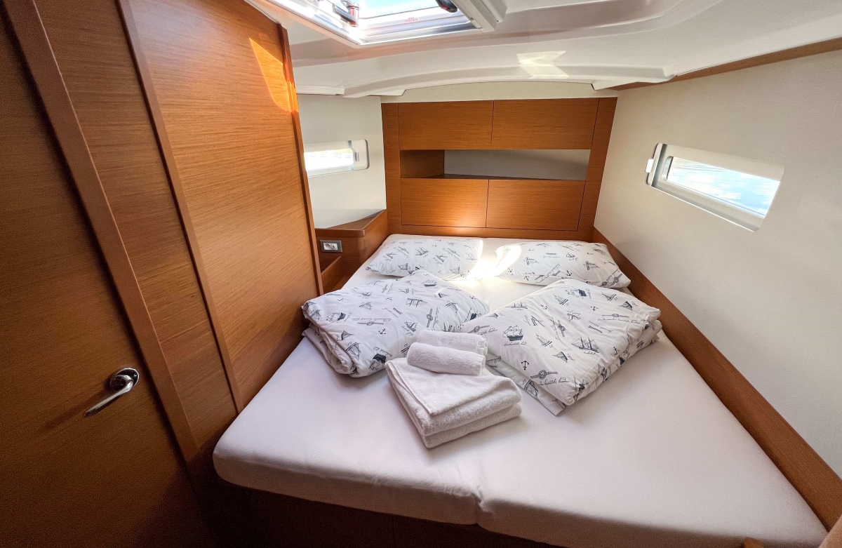 Comfortable cabin with a made-up double berth aboard a KEK yacht